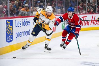 Oct 16, 2025; Montreal, Quebec, CAN; Nashville Predators left wing Michael Bunting (58) plays the puck against Montreal Canadiens right wing Cole Caufield (13) during the first period at Bell Centre. Mandatory Credit: David Kirouac-Imagn Images