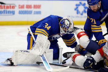 Oct 18, 2025; Buffalo, New York, USA;  Buffalo Sabres goaltender Alex Lyon (34) makes a save and looks to cover up the puck during the first period against the Florida Panthers at KeyBank Center. Mandatory Credit: Timothy T. Ludwig-Imagn Images