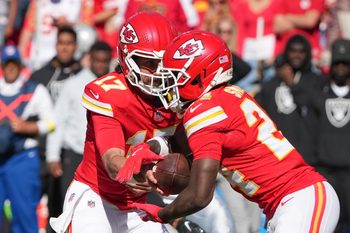 Oct 19, 2025; Kansas City, Missouri, USA; Kansas City Chiefs quarterback Gardner Minshew (17) hands teh ball to running back Brashard Smith (24) against the Las Vegas Raiders during the fourth quarter of the game at GEHA Field at Arrowhead Stadium. Mandatory Credit: Denny Medley-Imagn Images