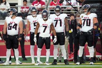 Oct 19, 2025; Santa Clara, California, USA; Atlanta Falcons running back Bijan Robinson (7) stands on the sideline with wide receiver Drake London (center left) and center Ryan Neuzil (64) and offensive tackles Elijah Wilkinson (71) and Jake Matthews (70) before the game against the San Francisco 49ers at Levi's Stadium. Mandatory Credit: Darren Yamashita-Imagn Images