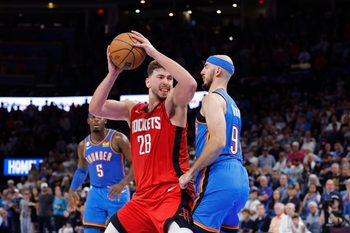 Oct 21, 2025; Oklahoma City, Oklahoma, USA; Houston Rockets center Alperen Sengun (28) drives against Oklahoma City Thunder guard Alex Caruso (9) during overtime at Paycom Center. Mandatory Credit: Alonzo Adams-Imagn Images