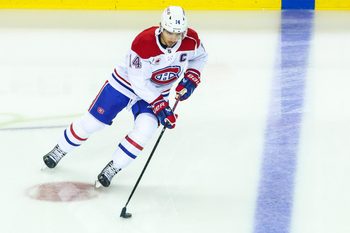 Oct 22, 2025; Calgary, Alberta, CAN; Montreal Canadiens center Nick Suzuki (14) skates with the puck during the warmup period against the Calgary Flames at Scotiabank Saddledome. Mandatory Credit: Sergei Belski-Imagn Images