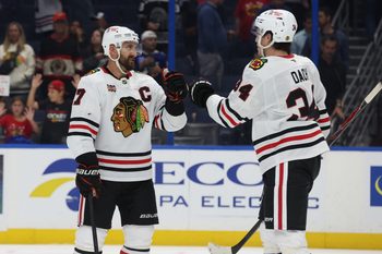 Oct 23, 2025; Tampa, Florida, USA; Chicago Blackhawks left wing Nick Foligno (17) and center Colton Dach (34) celebrate after they beat the Tampa Bay Lightning at Benchmark International Arena. Mandatory Credit: Kim Klement Neitzel-Imagn Images