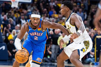 Oct 23, 2025; Indianapolis, Indiana, USA;  Oklahoma City Thunder guard Shai Gilgeous-Alexander (2) dribbles the ball while Indiana Pacers guard Bennedict Mathurin (00) defends in the second half at Gainbridge Fieldhouse. Mandatory Credit: Trevor Ruszkowski-Imagn Images