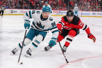 Oct 24, 2025; Newark, New Jersey, USA; San Jose Sharks center Philipp Kurashev (96) skates with the puck as New Jersey Devils right wing Timo Meier (28) defends during the third period at Prudential Center. Mandatory Credit: Ed Mulholland-Imagn Images