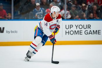 Oct 25, 2025; Vancouver, British Columbia, CAN; Montreal Canadiens forward Nick Suzuki (14) handles the puck against the Vancouver Canucks in the second period at Rogers Arena. Mandatory Credit: Bob Frid-Imagn Images
