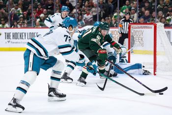 Oct 26, 2025; Saint Paul, Minnesota, USA; Minnesota Wild right wing Vladimir Tarasenko (91) and San Jose Sharks left wing William Eklund (72) compete for the puck during the third period at Grand Casino Arena. Mandatory Credit: Matt Krohn-Imagn Images