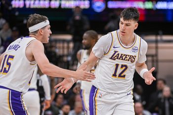 Oct 26, 2025; Sacramento, California, USA; Los Angeles Lakers forward Jake Laravia (12) high fives guard Austin Reaves (15) after scoring against the Sacramento Kings during the fourth quarter at Golden 1 Center. Mandatory Credit: Ed Szczepanski-Imagn Images