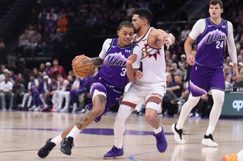 Oct 27, 2025; Salt Lake City, Utah, USA; Utah Jazz guard Keyonte George (3) drives against Phoenix Suns guard Devin Booker (1) during overtime at Delta Center. Mandatory Credit: Rob Gray-Imagn Images