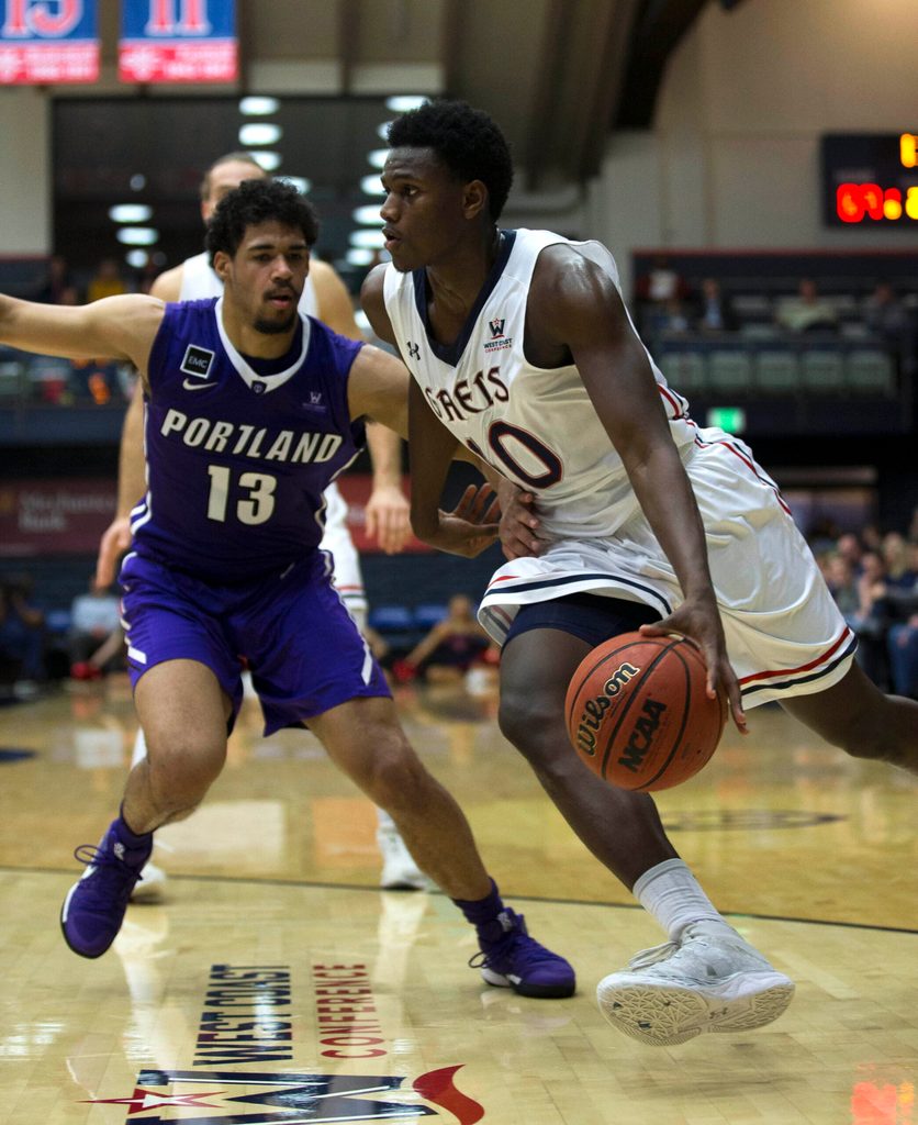 Jan 27, 2018; Moraga, CA, USA; Saint Mary's player Elijah Thomas (10) drives past Portland Pilots player Franklin Porter (13) in the second half of an NCAA men's college basketball game at McKeon Pavilion. Mandatory Credit: D. Ross Cameron-Imagn Images