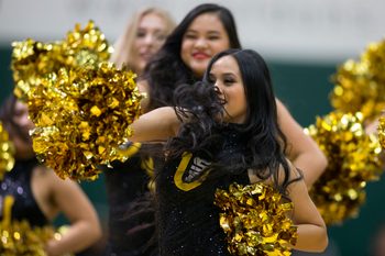 Feb 15, 2018; San Francisco, CA, USA; Cheerleaders entertain the crowd during a timeout in the first half of an NCAA men's college basketball game between the San Francisco Dons and the Saint Mary   s Gaels at War Memorial Gymnasium. Mandatory Credit: D. Ross Cameron-Imagn Images