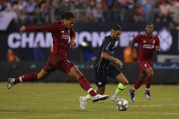 Jul 25, 2018; East Rutherford, NJ, USA; Liverpool defender Virgil Van Dijk (4) and Manchester City midfielder Riyad Mahrez (26) fight for the ball during the first half of an International Champions Cup soccer match at MetLife Stadium. Mandatory Credit: Brad Penner-Imagn Images