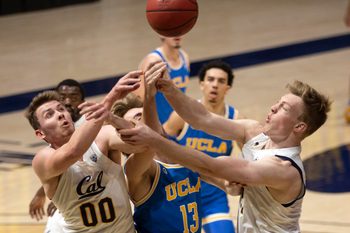 Jan 21, 2021; Berkeley, California, USA; UCLA Bruins guard Jake Kyman (13) vies for a rebound with California Golden Bears defenders Ryan Betley (00) and Lars Thiemann (21) during the first half of an NCAA men s college basketball game at Haas Pavilion. Mandatory Credit: D. Ross Cameron-Imagn Images