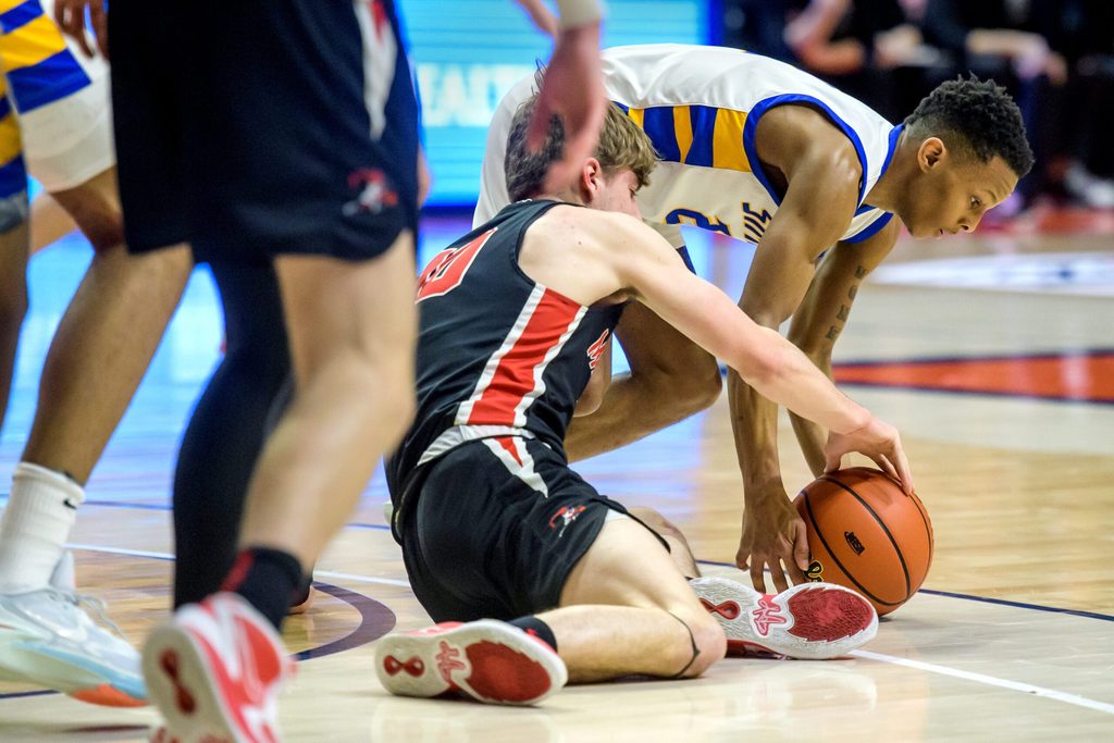 Chicago Simeon's Jalen Griffith and Metamora's Tyler Mason struggle for a loose ball in the first half of the Class 3A basketball state title game Saturday, March 11, 2023 at State Farm Center in Champaign. The Redbirds took the title 46-42.