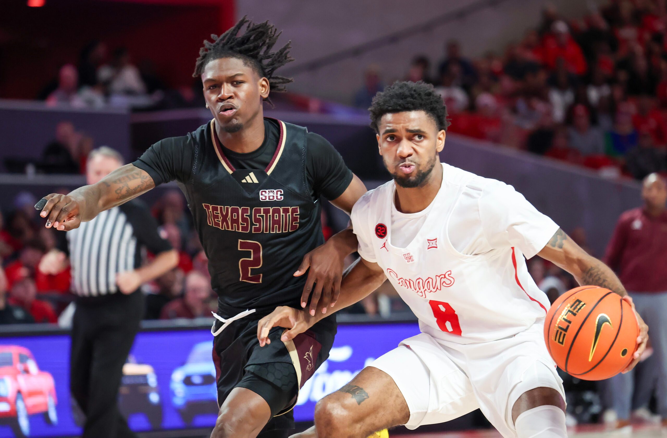 Dec 21, 2023; Houston, Texas, USA;  Houston Cougars guard Mylik Wilson (8) dribbles against Texas State Bobcats guard Dontae Horne (2) in the second half at Fertitta Center. Mandatory Credit: Thomas Shea-Imagn Images