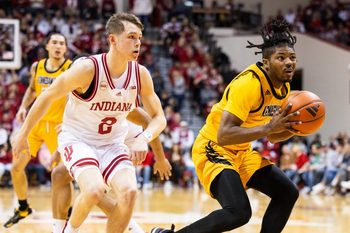 Dec 29, 2023; Bloomington, Indiana, USA; Kennesaw State Owls guard Terrell Burden (1) shoots the ball while Indiana Hoosiers guard Gabe Cupps (2) defends in the second half at Simon Skjodt Assembly Hall. Mandatory Credit: Trevor Ruszkowski-Imagn Images