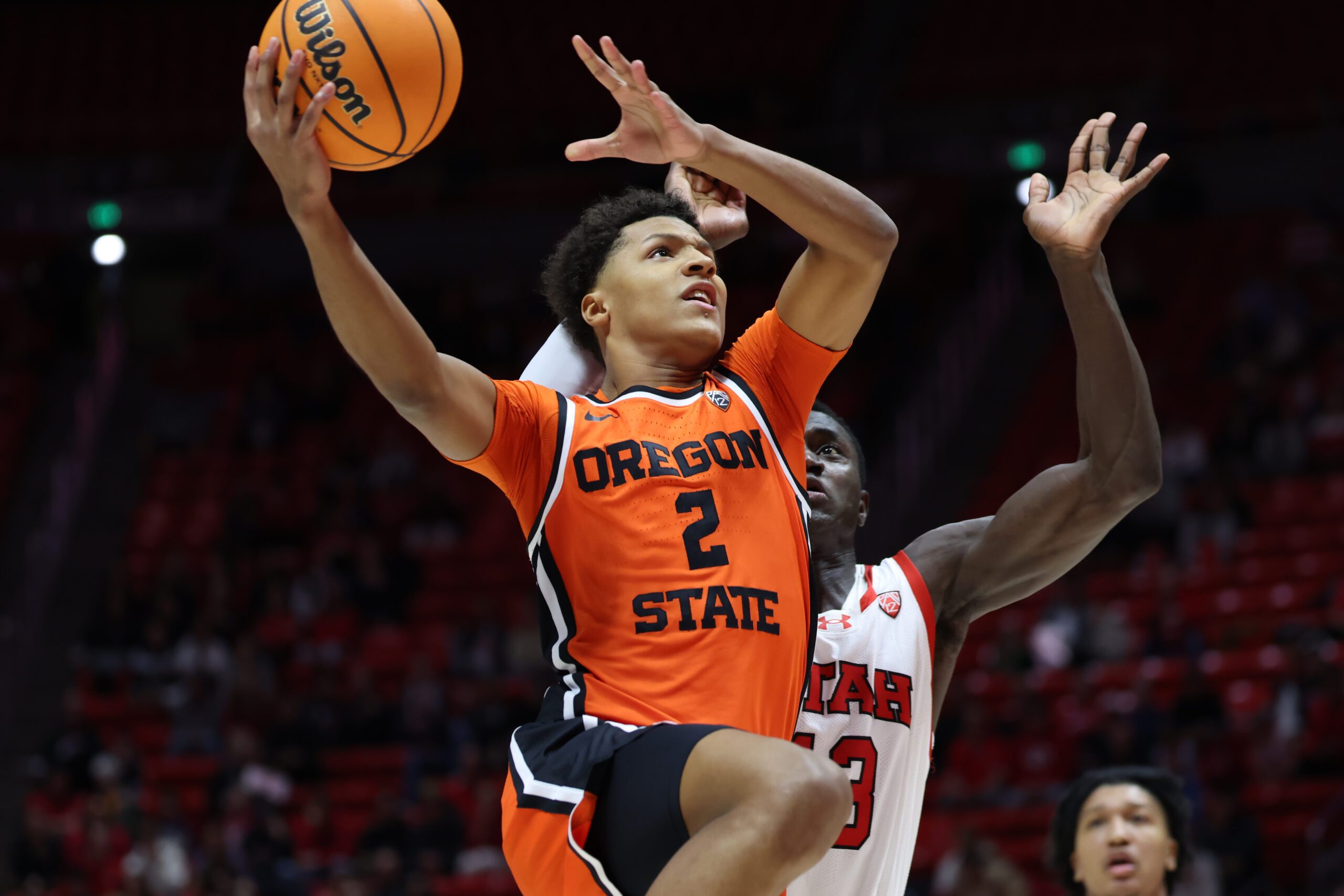 Jan 18, 2024; Salt Lake City, Utah, USA; Oregon State Beavers guard Josiah Lake II (2) goes to the basket past Utah Utes center Keba Keita (13) during the first half at Jon M. Huntsman Center. Mandatory Credit: Rob Gray-Imagn Images