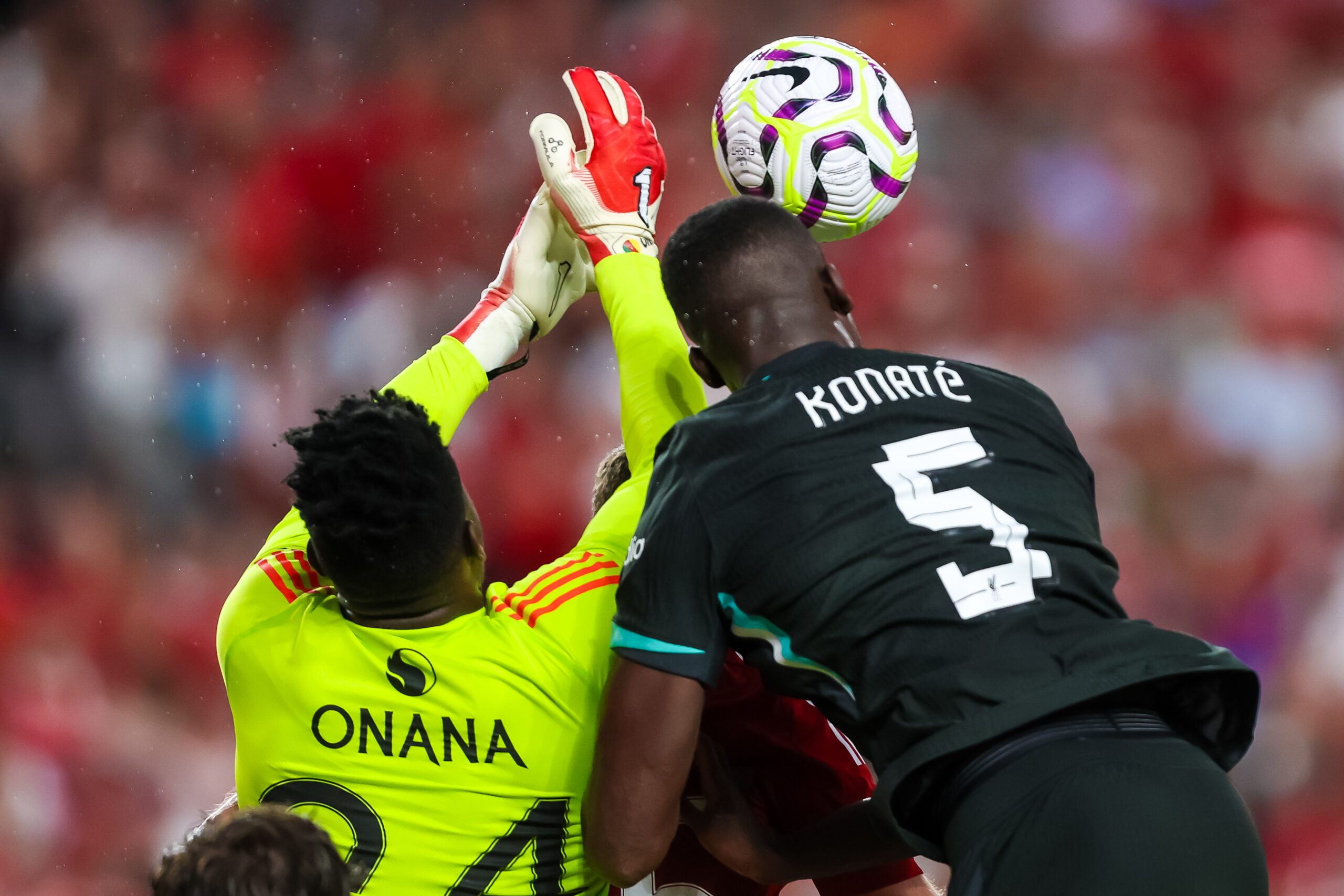 Aug 3, 2024; Columbia, South Carolina, USA;  Manchester United goalkeeper André Onana (24) and Liverpool defender Ibrahima Konaté (5) battle for the ball at Williams-Brice Stadium. Mandatory Credit: Jeff Blake-Imagn Images