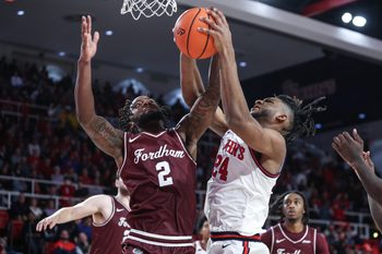 Nov 4, 2024; Queens, New York, USA;  Fordham Rams forward Romad Dean (2) and St. John's Red Storm forward Zuby Ejiofor (24) fight for a rebound in the second half at Carnesecca Arena. Mandatory Credit: Wendell Cruz-Imagn Images