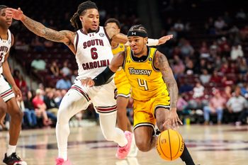 Nov 12, 2024; Columbia, South Carolina, USA; Towson Tigers guard Dylan Williamson (4) drives past South Carolina Gamecocks guard Jamarii Thomas (6) in the second half at Colonial Life Arena. Mandatory Credit: Jeff Blake-Imagn Images