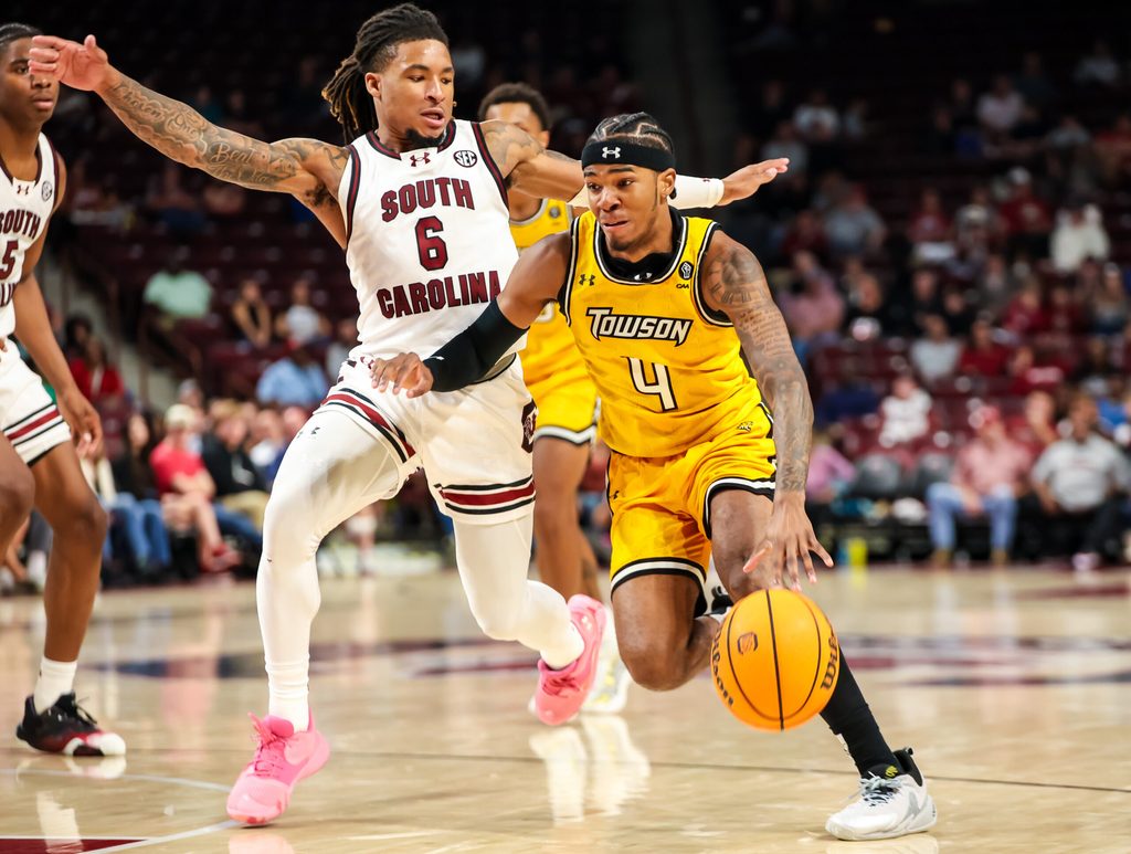 Nov 12, 2024; Columbia, South Carolina, USA; Towson Tigers guard Dylan Williamson (4) drives past South Carolina Gamecocks guard Jamarii Thomas (6) in the second half at Colonial Life Arena. Mandatory Credit: Jeff Blake-Imagn Images