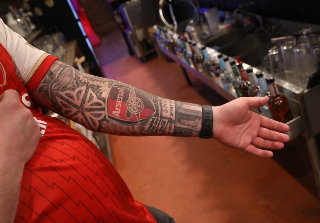 Owner Dan Zambito shows his deep love of the game of soccer tattooed on his arm at his newly opened Boot Room Pub at 198 Winton Road in Rochester Friday, Dec. 6, 2024.