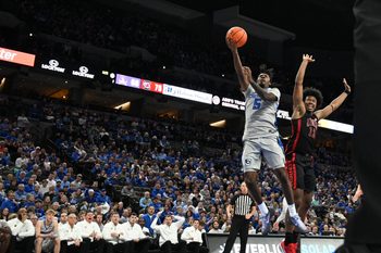 Dec 7, 2024; Omaha, Nebraska, USA;  Creighton Bluejays guard Jamiya Neal (5) scores against UNLV Rebels forward Jacob Bannarbie (12) in the second half at CHI Health Center Omaha. Mandatory Credit: Steven Branscombe-Imagn Images