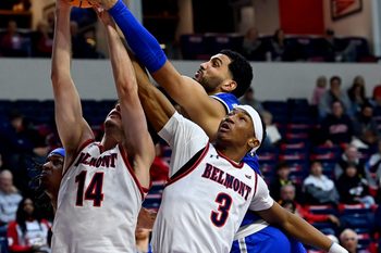 Belmont’s Sam Orme (14), Jonathan Pierre (3) and MTSU forward Essam Mostafa, right, go up for a rebound during an NCAA college basketball game Saturday, Dec. 7, 2024, in Nashville, Tenn.