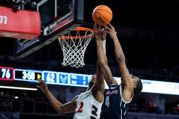 Dec 8, 2024; Cincinnati, Ohio, USA; Cincinnati Bearcats forward Arrinten Page (22) battles for a rebound against Howard Bison forward Miles Stewart (4) in the second half at Fifth Third Arena. Mandatory Credit: Aaron Doster-Imagn Images