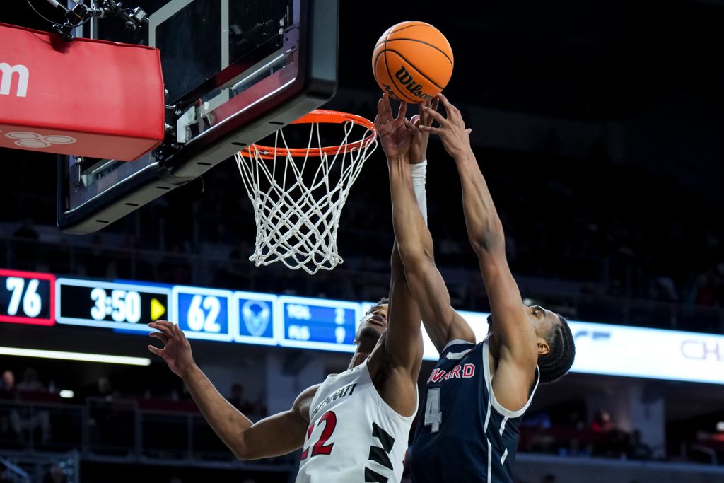 Dec 8, 2024; Cincinnati, Ohio, USA; Cincinnati Bearcats forward Arrinten Page (22) battles for a rebound against Howard Bison forward Miles Stewart (4) in the second half at Fifth Third Arena. Mandatory Credit: Aaron Doster-Imagn Images