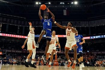 Dec 19, 2024; Austin, Texas, USA; New Orleans Privateers guard Jah Short (2) drives to the basket past Texas Longhorns guard Jordan Pope (0) and forward Ze'Rik Onyema (21) during the first half at Moody Center. Mandatory Credit: Scott Wachter-Imagn Images