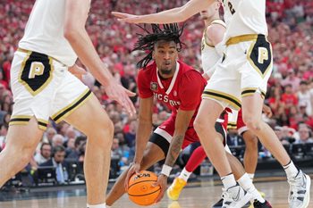 North Carolina State Wolfpack guard Jayden Taylor (1) drives into Purdue Boilermakers guard Fletcher Loyer (2) during the NCAA Men's Basketball Tournament Final Four game, Saturday, April 6, 2024, at State Farm Stadium in Glendale, Ariz.