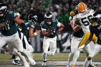 Jan 12, 2025; Philadelphia, Pennsylvania, USA; Philadelphia Eagles running back Saquon Barkley (26) rushes the ball against the Green Bay Packers during the second half in an NFC wild card game at Lincoln Financial Field. Mandatory Credit: Eric Hartline-Imagn Images