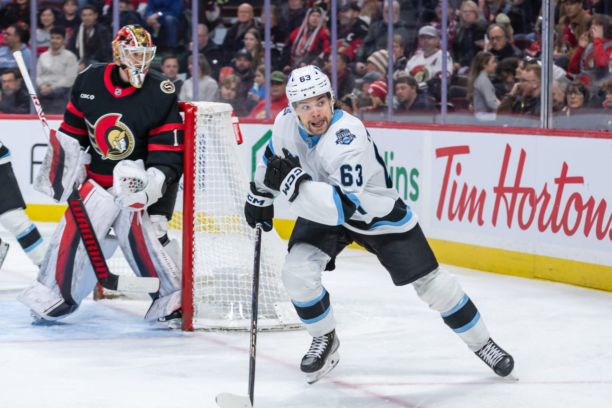 Jan 26, 2025; Ottawa, Ontario, CAN; Utah left wing Matias Maccelli (63) chases the puck in the second period against the Ottawa Senators at the Canadian Tire Centre. Mandatory Credit: Marc DesRosiers-Imagn Images