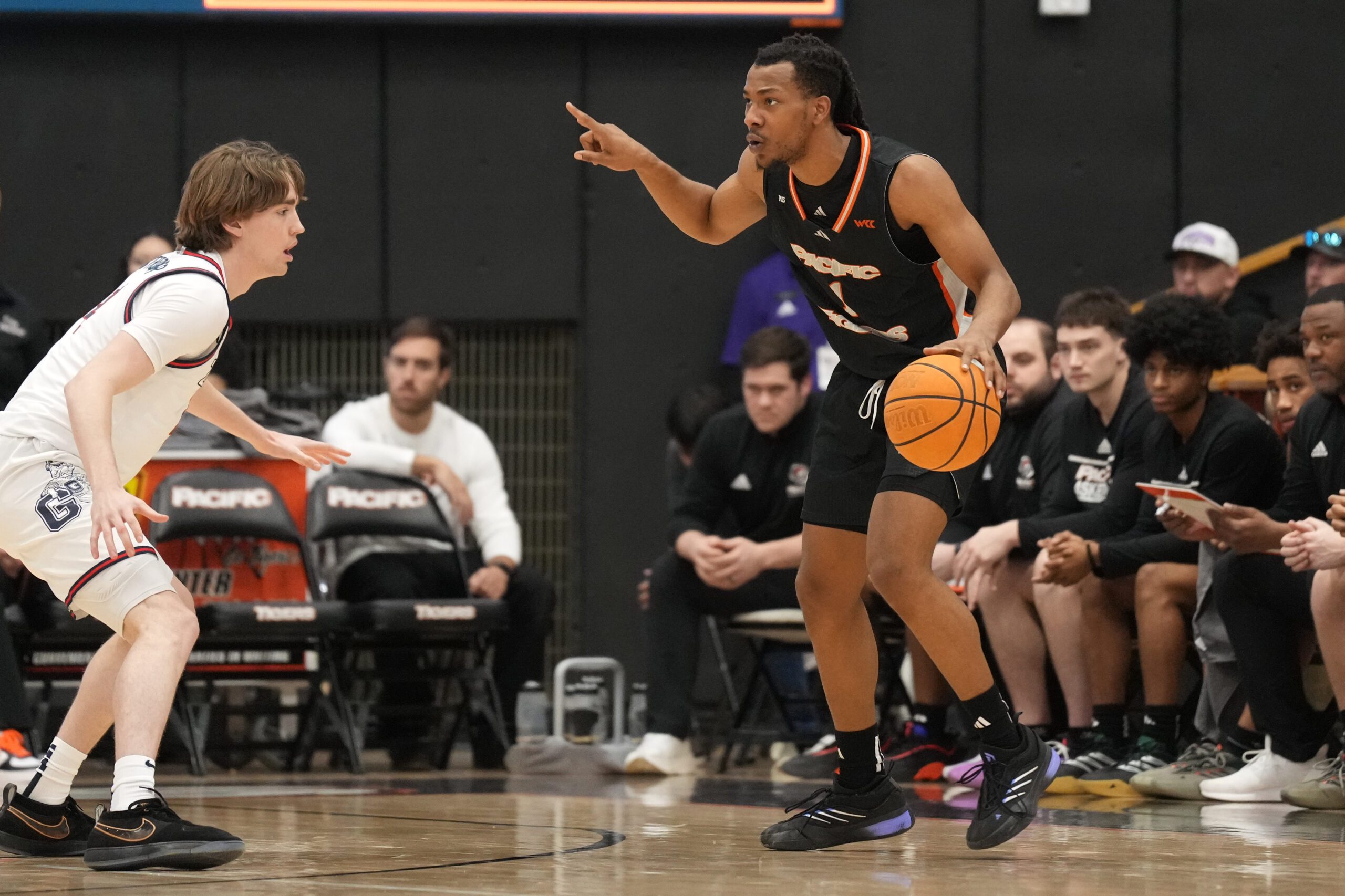 Feb 8, 2025; Stockton, California, USA; Pacific Tigers guard Lamar Washington (right) dribbles against Gonzaga Bulldogs guard Dusty Stromer (left) during the second half at Alex G. Spanos Center. Mandatory Credit: Darren Yamashita-Imagn Images