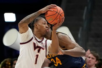 Mar 11, 2025; Charlotte, NC, USA; Virginia Tech Hokies forward Tobi Lawal (1) with the ball as California Golden Bears forward Lee Dort (34) defends in the second half at Spectrum Center. Mandatory Credit: Bob Donnan-Imagn Images