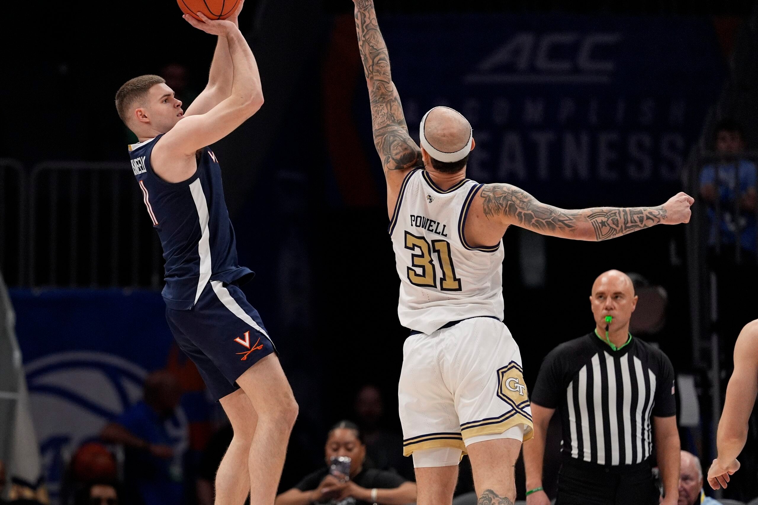 Mar 12, 2025; Charlotte, NC, USA;Virginia Cavaliers guard Isaac McKneely (11) shoots the jumper over Georgia Tech Yellow Jackets forward Duncan Powell (31) during the second half at Spectrum Center. Mandatory Credit: Jim Dedmon-Imagn Images