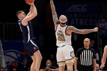 Mar 12, 2025; Charlotte, NC, USA;Virginia Cavaliers guard Isaac McKneely (11) shoots the jumper over Georgia Tech Yellow Jackets forward Duncan Powell (31) during the second half at Spectrum Center. Mandatory Credit: Jim Dedmon-Imagn Images