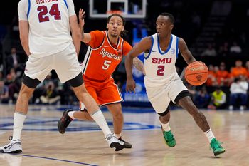 Mar 12, 2025; Charlotte, NC, USA;Southern Methodist Mustangs guard Boopie Miller (2) goes to the basket against Syracuse Orange guard Jaquan Carlos (5) during the second half at Spectrum Center. Mandatory Credit: Jim Dedmon-Imagn Images