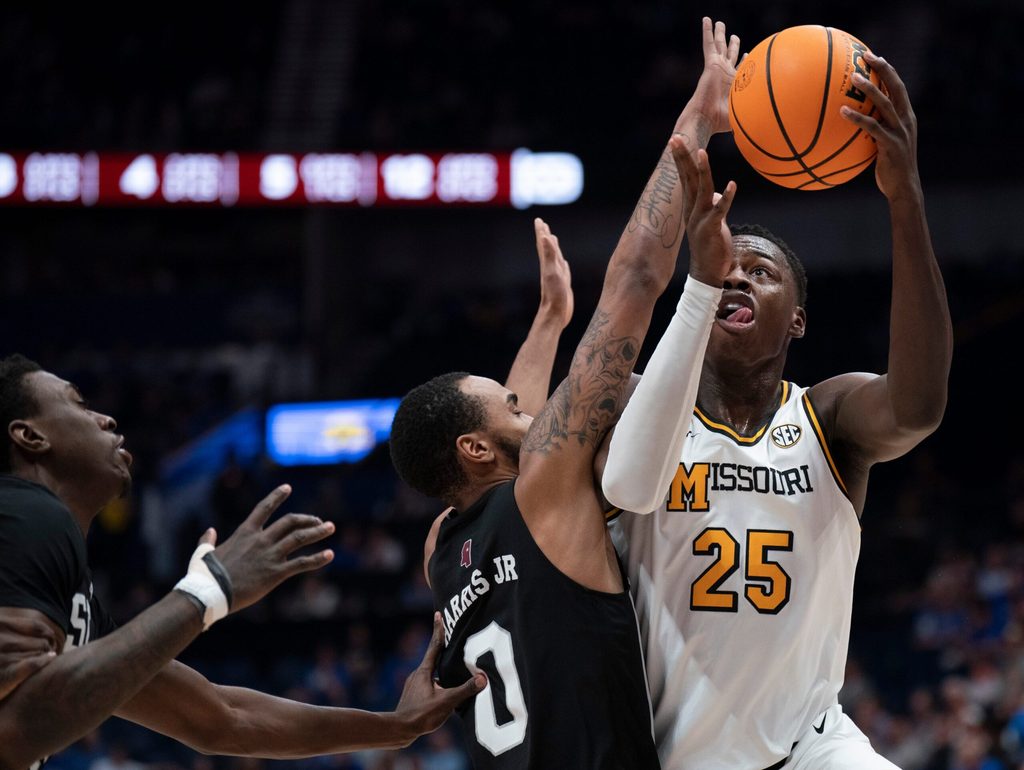 Missouri Tigers guard Mark Mitchell (25) shoots over Mississippi State Bulldogs guard Claudell Harris Jr. (0) during their second round game of the SEC Men's Basketball Tournament at Bridgestone Arena in Nashville, Tenn., Thursday, March 13, 2025.