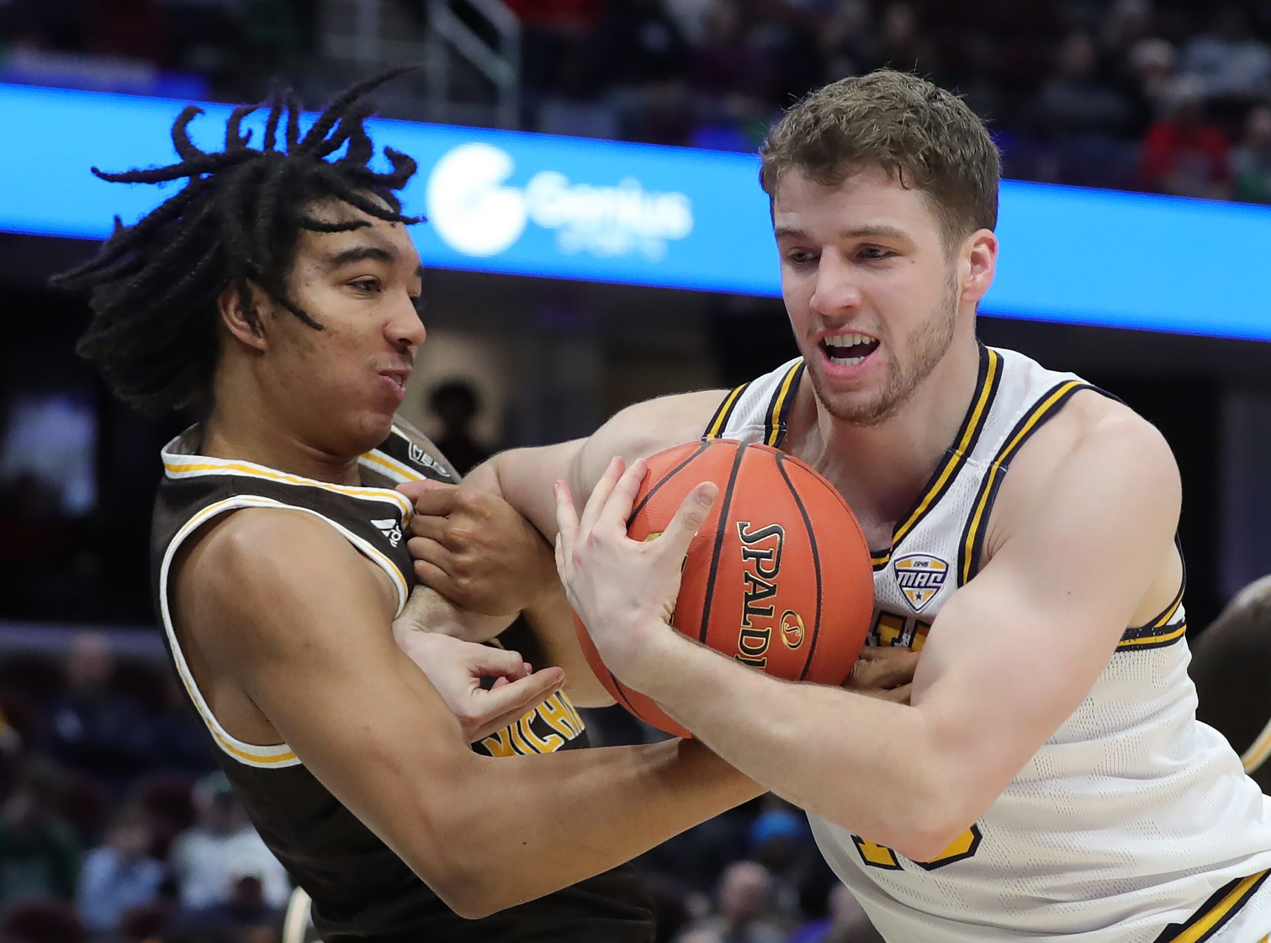 Kent State Golden Flashes guard Mike Bekelja (15) and Western Michigan Broncos guard EJ Ryans (3) fight for the ball during the first half of an NCAA college basketball game in the quarterfinals of the Mid-American Conference Tournament at Rocket Arena on Thursday, March 13, 2025, in Cleveland, Ohio.