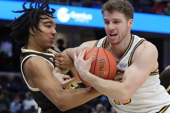 Kent State Golden Flashes guard Mike Bekelja (15) and Western Michigan Broncos guard EJ Ryans (3) fight for the ball during the first half of an NCAA college basketball game in the quarterfinals of the Mid-American Conference Tournament at Rocket Arena on Thursday, March 13, 2025, in Cleveland, Ohio.