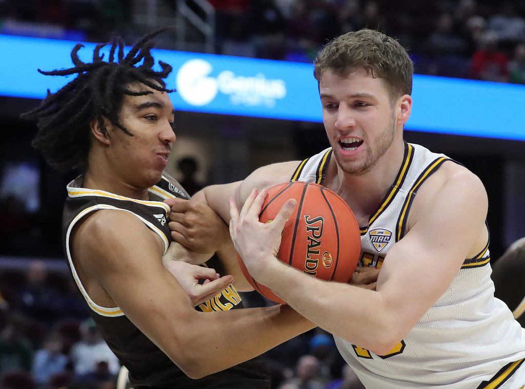 Kent State Golden Flashes guard Mike Bekelja (15) and Western Michigan Broncos guard EJ Ryans (3) fight for the ball during the first half of an NCAA college basketball game in the quarterfinals of the Mid-American Conference Tournament at Rocket Arena on Thursday, March 13, 2025, in Cleveland, Ohio.