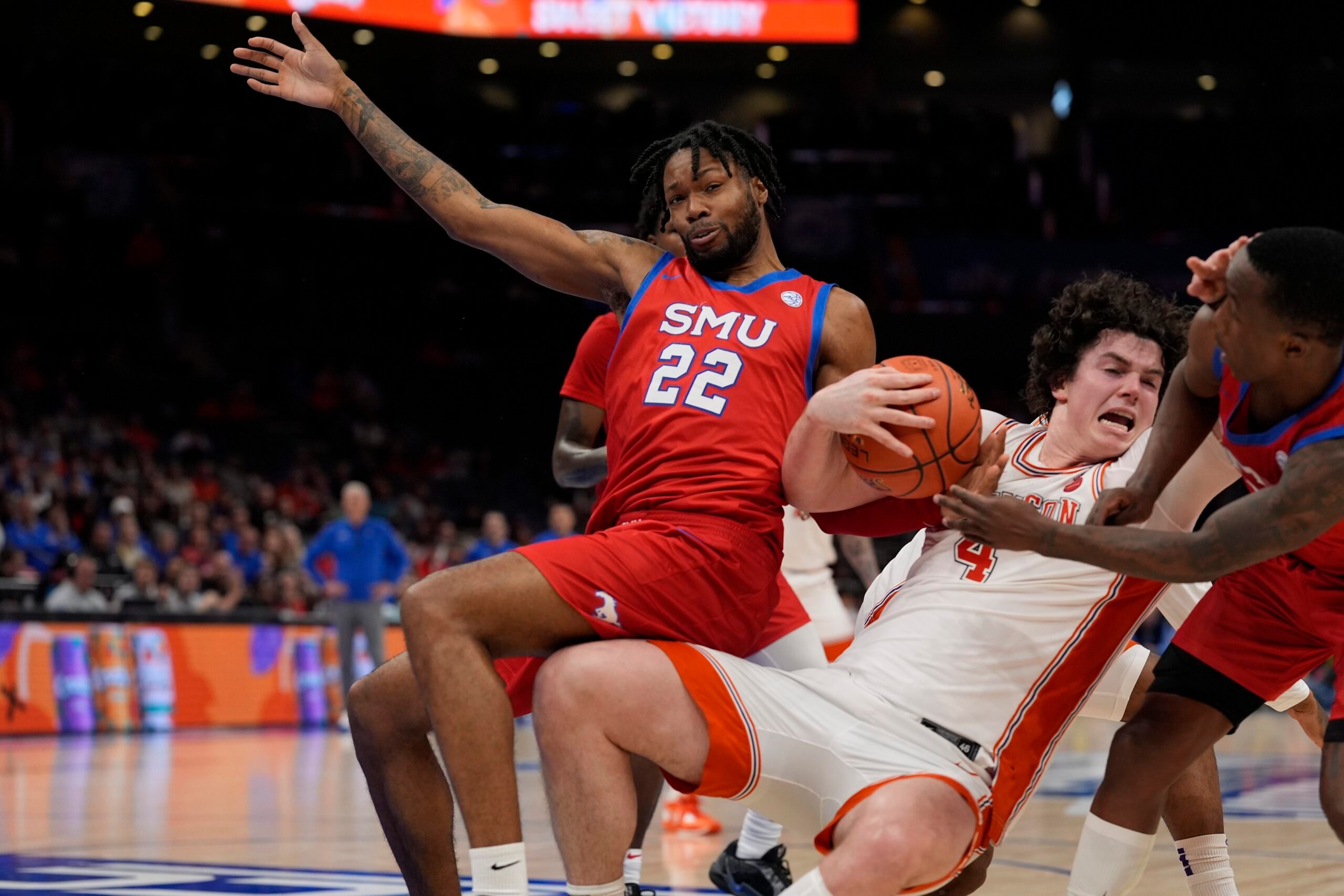 Mar 13, 2025; Charlotte, NC, USA; Clemson Tigers forward Ian Schieffelin (4) holds onto the rebound against Southern Methodist Mustangs forward Keon Ambrose-Hylton (22) and guard Chuck Harris (3) during the second half at Spectrum Center. Mandatory Credit: Jim Dedmon-Imagn Images