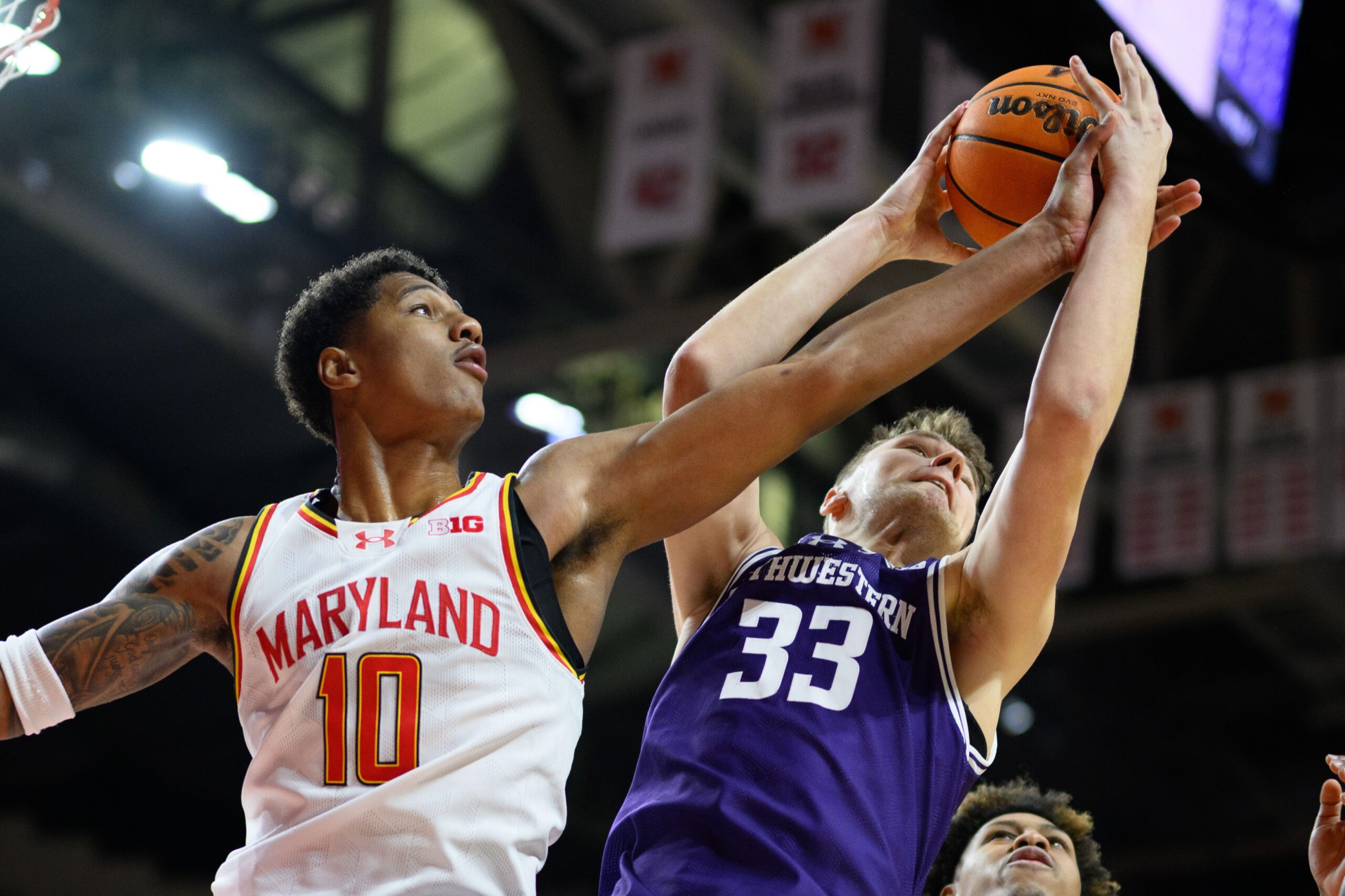 Mar 8, 2025; College Park, Maryland, USA; Maryland Terrapins forward Julian Reese (10) and Northwestern Wildcats forward Luke Hunger (33) battle for a rebound during the first half at Xfinity Center. Mandatory Credit: Reggie Hildred-Imagn Images