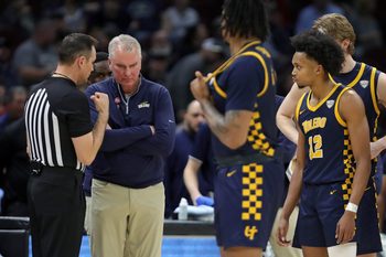 Toledo Rockets head coach Tod Kowalczyk receives an explanation from a referee after guard Seth Hubbard (12) was charged with a technical foul during the second half of an NCAA college basketball game in the semifinals of the Mid-American Conference Tournament at Rocket Arena on Friday, March 14, 2025, in Cleveland, Ohio.