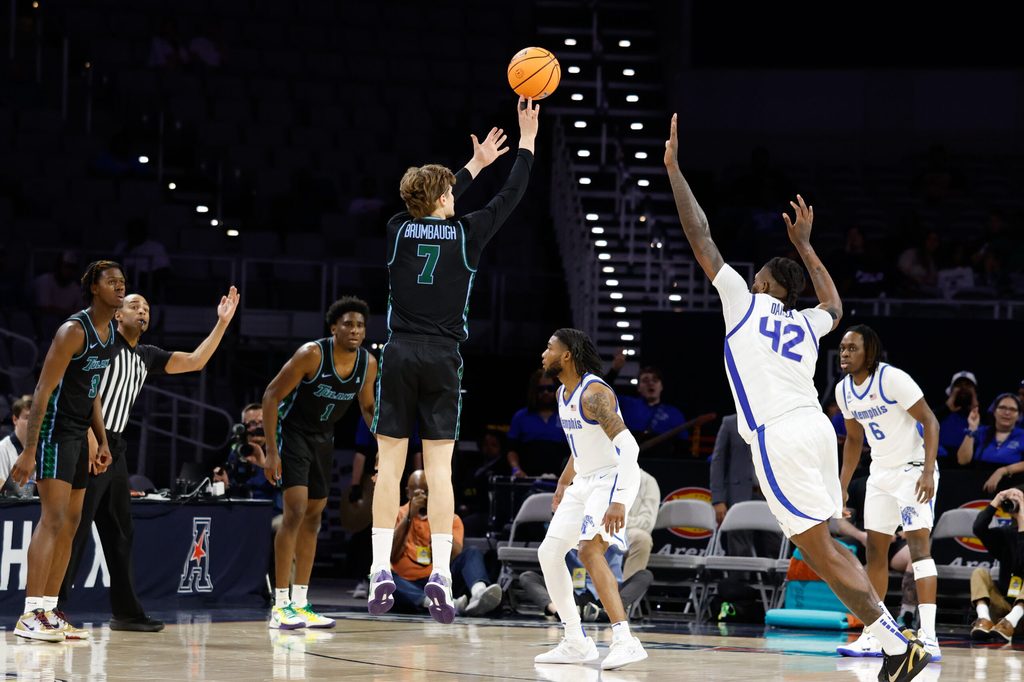 Mar 15, 2025; Fort Worth, TX, USA; Tulane Green Wave guard Rowan Brumbaugh (7) scores a three-point basket against Memphis Tigers forward Dain Dainja (42) during the first half at Dickies Arena. Mandatory Credit: Chris Jones-Imagn Images