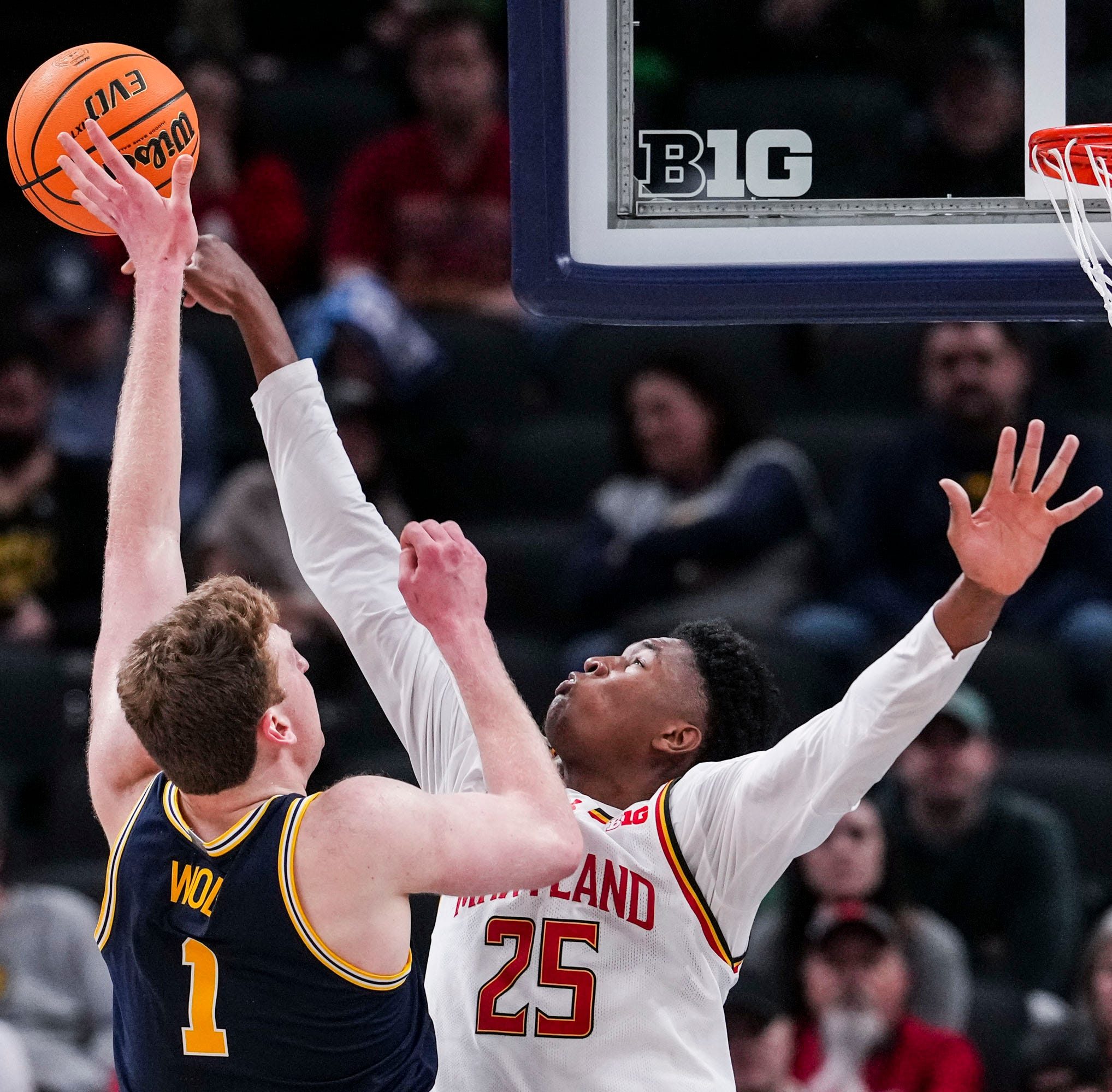 Maryland Terrapins center Derik Queen (25) attempts to stop Michigan Wolverines center Danny Wolf (1) on Saturday, March 15, 2025, in a semifinals game at the 2025 TIAA Big Ten Men’s Basketball Tournament between the Michigan Wolverines and the Maryland Terrapins at Gainbridge Fieldhouse in Indianapolis.
