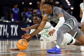 Mar 15, 2025; Fort Worth, TX, USA; UAB Blazers guard Ja'Borri McGhee (2) and North Texas Mean Green guard Johnathan Massie (2) chase a loose ball during the first half at Dickies Arena. Mandatory Credit: Chris Jones-Imagn Images