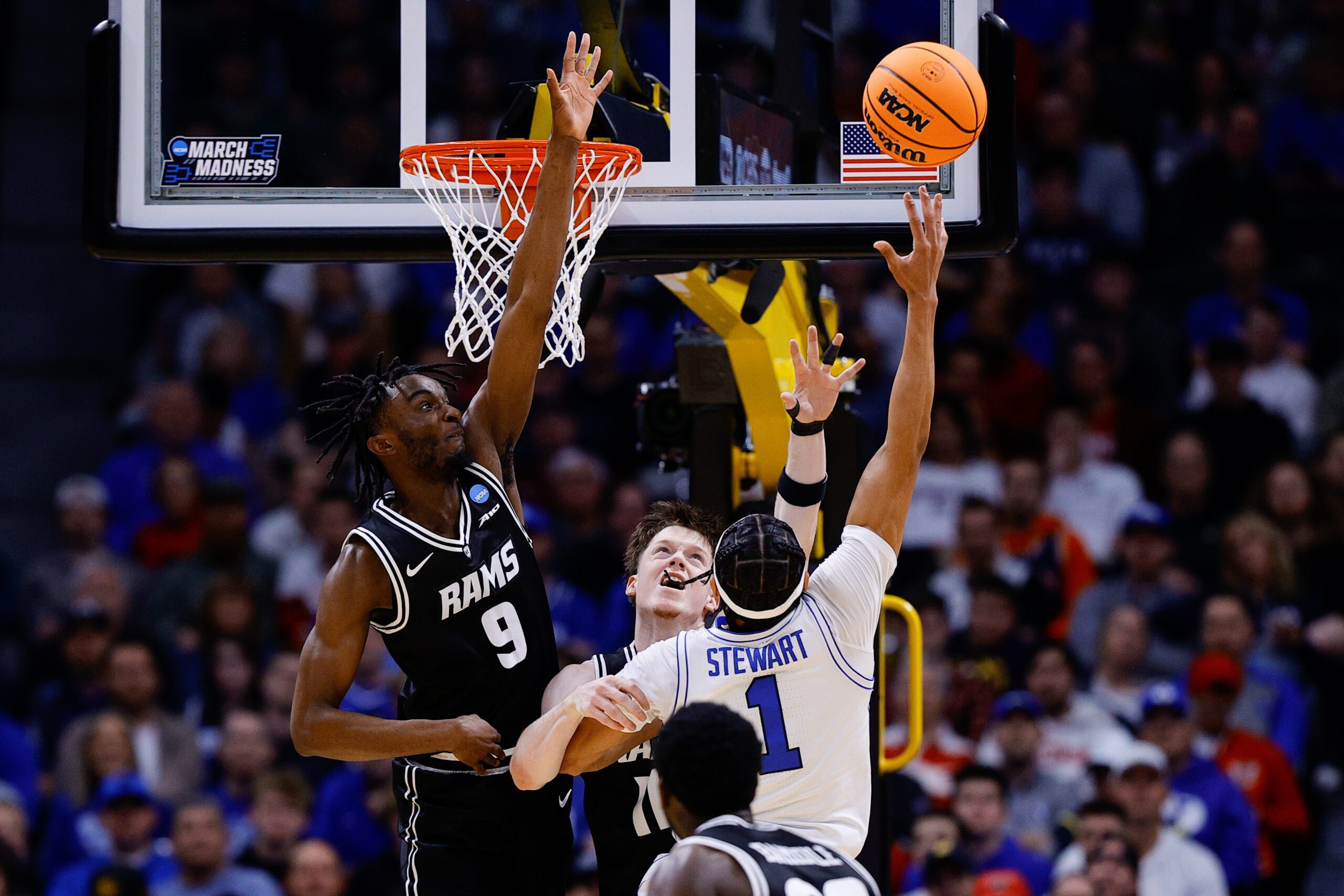 Mar 20, 2025; Denver, CO, USA; VCU Rams forward Luke Bamgboye (9) and guard Max Shulga (11) defends against a shot by Brigham Young Cougars guard Trey Stewart (1) during the first half in the first round of the NCAA Tournament at Ball Arena. Mandatory Credit: Isaiah J. Downing-Imagn Images